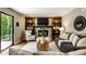 Relaxing living room with a stone fireplace, built-in shelving, and a sliding glass door at 725 Sugarbush Dr, Zionsville, IN 46077