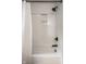 Modern white tiled shower with black hardware and recessed shelving at 725 Sugarbush Dr, Zionsville, IN 46077