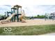 Neighborhood playground featuring slides, swings, and a view of the community pool nearby at 13094 Overview Dr # 5D, Fishers, IN 46037