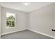 Bright bedroom with grey carpet and a large window at 1647 Sheldon St, Indianapolis, IN 46218