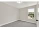Well-lit bedroom with grey carpet and window view at 1647 Sheldon St, Indianapolis, IN 46218