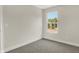 Simple bedroom with grey carpet and a window at 1647 Sheldon St, Indianapolis, IN 46218