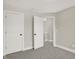 Neutral-toned bedroom with carpet and multiple doors at 1647 Sheldon St, Indianapolis, IN 46218