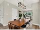 Bright dining room with a mid-century modern table and chairs, and a view of kitchen at 1647 Sheldon St, Indianapolis, IN 46218