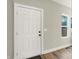 Bright entryway with white door and wood-look floors at 1647 Sheldon St, Indianapolis, IN 46218