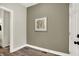 Hallway with taupe walls, hardwood floors, and framed artwork at 1647 Sheldon St, Indianapolis, IN 46218