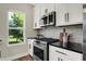 Modern kitchen with white cabinets and stainless steel appliances at 1647 Sheldon St, Indianapolis, IN 46218