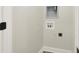 Small laundry area with hookups and built-in shelving at 1647 Sheldon St, Indianapolis, IN 46218