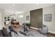 Modern living room with an accent wall, comfortable seating, and views into the dining area and kitchen at 1647 Sheldon St, Indianapolis, IN 46218