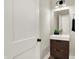 Modern powder room featuring floating vanity and mirror at 1647 Sheldon St, Indianapolis, IN 46218