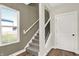Elegant staircase with gray carpeting and black balusters at 1647 Sheldon St, Indianapolis, IN 46218