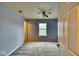 Cozy carpeted bedroom with ceiling fan, a window, and a walk-in closet at 2225 Shadowbrook Dr, Plainfield, IN 46168