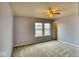 Comfortable bedroom features plush carpet, ceiling fan, and dual windows at 2225 Shadowbrook Dr, Plainfield, IN 46168