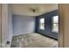 Carpeted bedroom boasts a ceiling fan and plenty of natural light from dual windows at 2225 Shadowbrook Dr, Plainfield, IN 46168