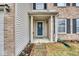 Covered front porch with columns and a blue front door at 2225 Shadowbrook Dr, Plainfield, IN 46168