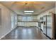 Bright kitchen featuring stainless steel appliances, white cabinetry, and dark wood flooring at 2225 Shadowbrook Dr, Plainfield, IN 46168