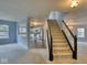 Open-concept living room with staircase and view of the kitchen with stainless steel appliances at 2225 Shadowbrook Dr, Plainfield, IN 46168