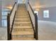 Carpeted stairs with dark wood railings leading to upper level at 2225 Shadowbrook Dr, Plainfield, IN 46168