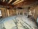 Living room with exposed framing, brick fireplace, and wood beam, offering potential for renovation at 4026 W 141St St, Carmel, IN 46074