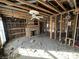 Living room featuring exposed framing, brick fireplace, and ceiling fan awaiting a new design at 4026 W 141St St, Carmel, IN 46074