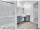 Modern bathroom featuring a glass shower, double vanity, and wood-look flooring at 5743 Cr W 750 N, McCordsville, IN 46055