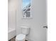 Clean bathroom featuring a white toilet, neutral walls, and a window providing natural light at 5743 Cr W 750 N, McCordsville, IN 46055
