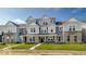 Charming townhome showcases gray siding, stone accents, and a well-manicured lawn at 5743 Cr W 750 N, McCordsville, IN 46055