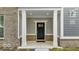 Charming covered porch with white columns and a stylish black front door at 5743 Cr W 750 N, McCordsville, IN 46055