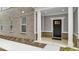 Inviting covered front porch features gray brick and tiled walls and a white door at 5743 Cr W 750 N, McCordsville, IN 46055