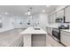 Beautiful open kitchen with stainless steel appliances, center island, and expansive hardwood floors at 5743 Cr W 750 N, McCordsville, IN 46055