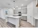 Spacious kitchen features stainless appliances, subway tile backsplash, gray cabinets, and center island at 5743 Cr W 750 N, McCordsville, IN 46055
