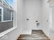 Functional laundry area with wood-look flooring, utility connections, and a window to let in natural light at 5743 Cr W 750 N, McCordsville, IN 46055