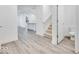 Open-concept living space with kitchen view, stairs, and half-bath at 5743 Cr W 750 N, McCordsville, IN 46055