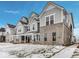 Exterior view of gray and white multi-story townhomes with snow-covered lawns, showcasing modern architecture at 5743 Cr W 750 N, McCordsville, IN 46055