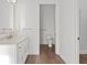 Bathroom features marble counters, white cabinets, and gold hardware with a toilet in separate room at 1155 S Rangeline Rd # 503, Carmel, IN 46032