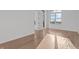 Empty bedroom featuring wood floors, modern trim and windows providing natural light at 1155 S Rangeline Rd # 503, Carmel, IN 46032