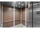 Inside an elevator featuring wood-paneled walls, handrails, and a modern, clean design at 1155 S Rangeline Rd # 503, Carmel, IN 46032