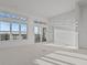 Bright, spacious living room with large windows and balcony access at 1155 S Rangeline Rd # 503, Carmel, IN 46032