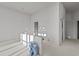 Bright living room featuring fresh white walls and paint buckets, bathed in sunlight at 1155 S Rangeline Rd # 503, Carmel, IN 46032