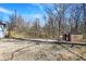 Spacious backyard featuring a gravel area, a shed, and surrounding natural landscape with trees at 7635 Grizzly Dr, Nineveh, IN 46164