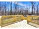 A new wooden deck overlooking a lush backyard with a wooden railing at 7635 Grizzly Dr, Nineveh, IN 46164