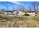 View of the backyard with a wood deck, vinyl siding and chain link fence at 7635 Grizzly Dr, Nineveh, IN 46164