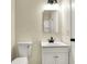 Bathroom featuring a toilet and a vanity with a sink and mirror at 7635 Grizzly Dr, Nineveh, IN 46164