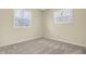 Bedroom featuring neutral carpet, two bright windows, and neutral paint at 7635 Grizzly Dr, Nineveh, IN 46164