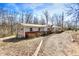 Ranch-style home featuring neutral siding with brick detail, a covered entryway, and gravel driveway at 7635 Grizzly Dr, Nineveh, IN 46164