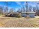 Ranch-style home featuring neutral siding, a covered entryway and set on a lot with mature trees and dormant vegetation at 7635 Grizzly Dr, Nineveh, IN 46164