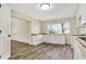 Updated kitchen boasts bright white cabinets, wood-look floors, contrasting countertops, and modern appliances with a view at 7635 Grizzly Dr, Nineveh, IN 46164