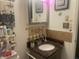 Well-decorated powder room featuring a granite countertop and charming decorative touches at 6438 Doris Dr, Indianapolis, IN 46214