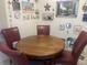Cozy dining area with a wooden table and red chairs, decorated with charming wall art at 6438 Doris Dr, Indianapolis, IN 46214