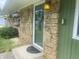 Close-up of the front door showcasing the stone facade and decorative floral arrangements at 6438 Doris Dr, Indianapolis, IN 46214